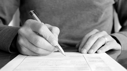 Person filling out paperwork